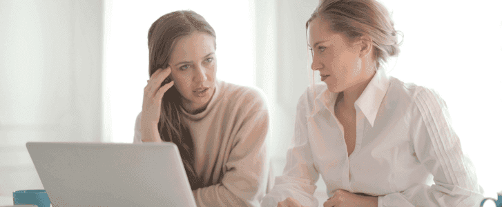 Thoughtful businesswomen discussing problems of not managing shadow IT in their office