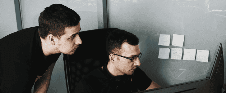 two IT co-workers in black tank top wearing eyeglasses learning how to manage shadow It with citizen development