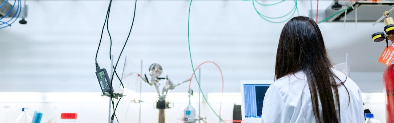 Lady in a lab conducting experiments for tech transfer process.